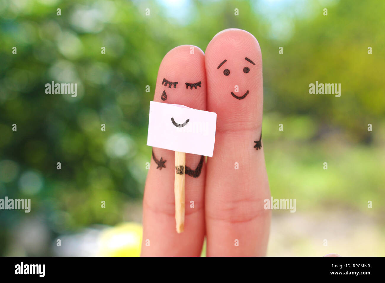 Fingers art of couple. Concept of woman hiding emotions, man is happy. Stock Photo