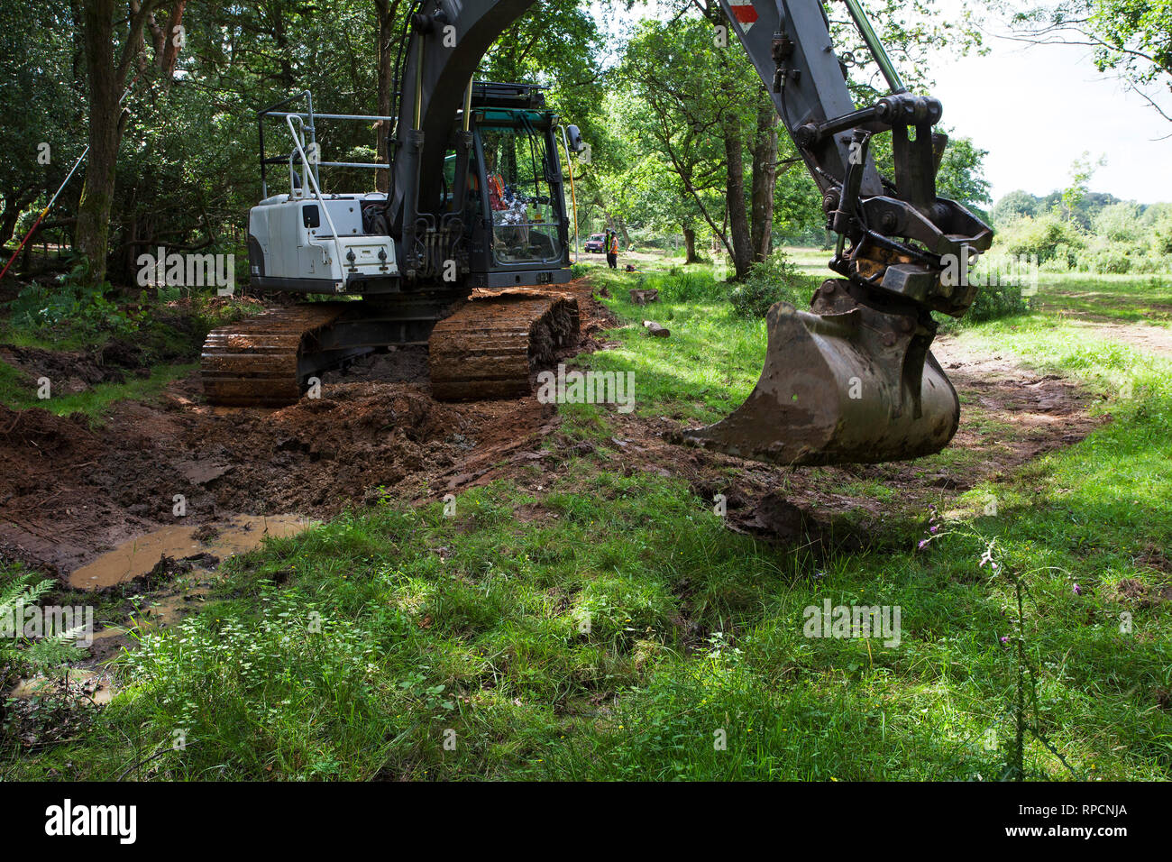 Digger involved in stream restoration work Wootton New Forest National