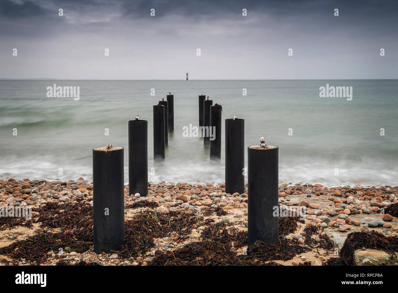 Pier posts in the ocean on stormy day. Viken, Sweden. Stock Photo