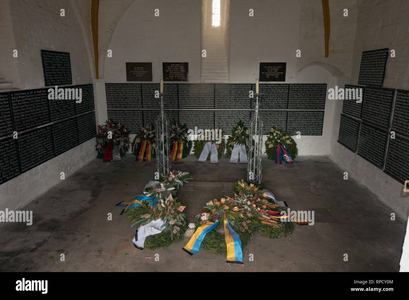 Memorial to war dead with laid wreaths. Norden. East Frisia. Lower Saxony. Germany. Stock Photo