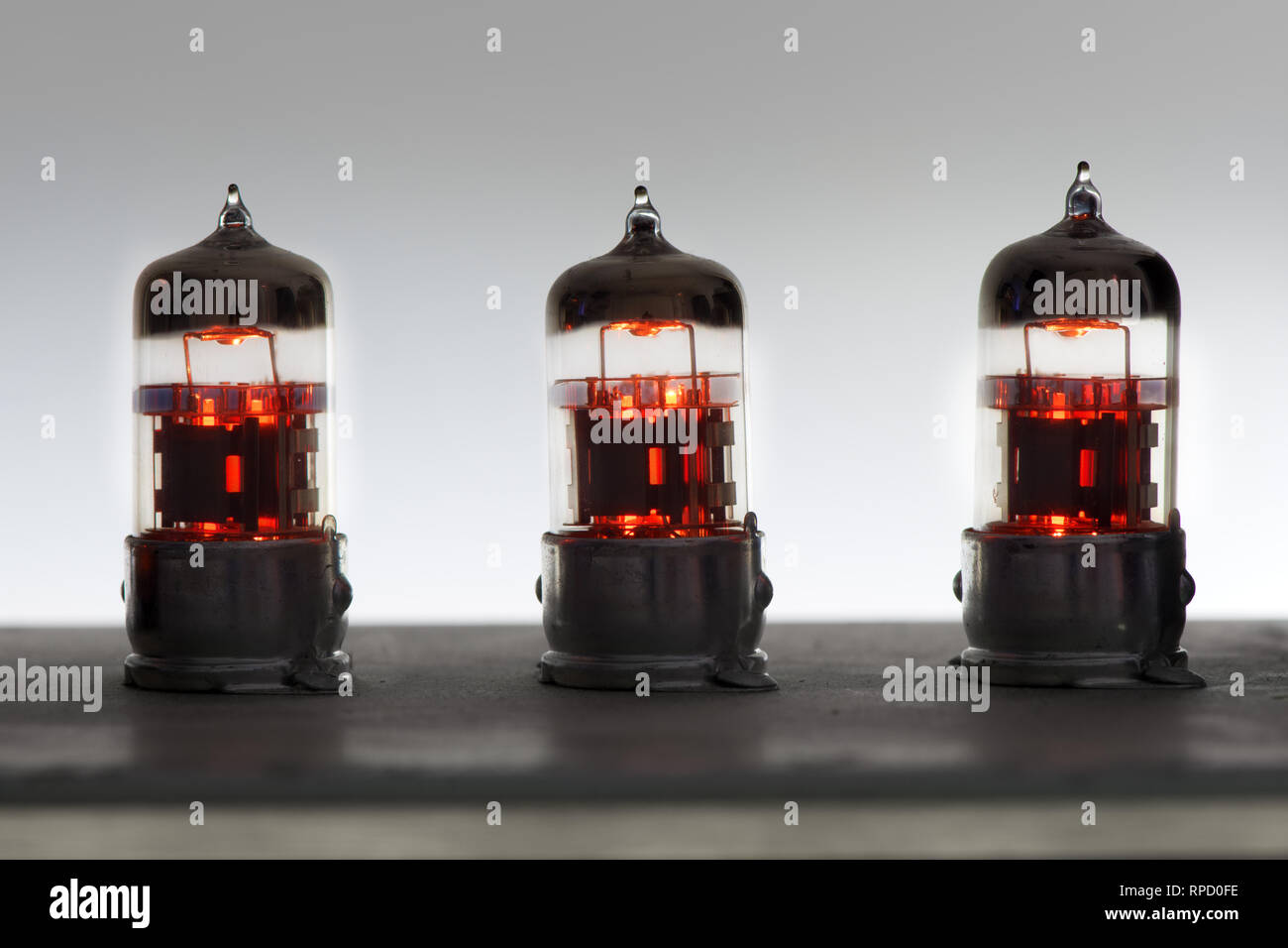 three orange vintage lighted amplifier tubes Stock Photo Alamy