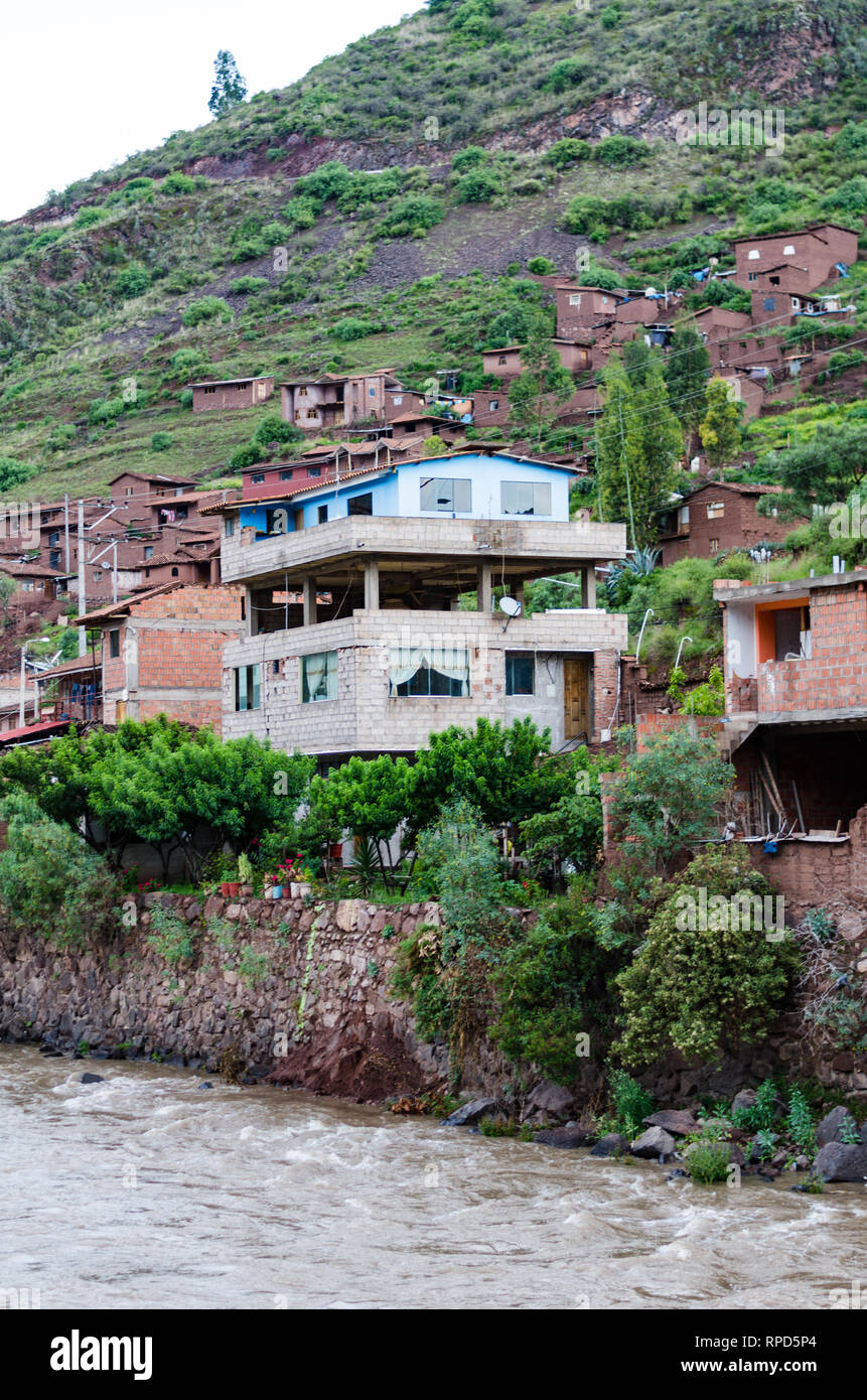 Traditional house on the edge of the Urubamba river in Pisac - Cusco. Stock Photo