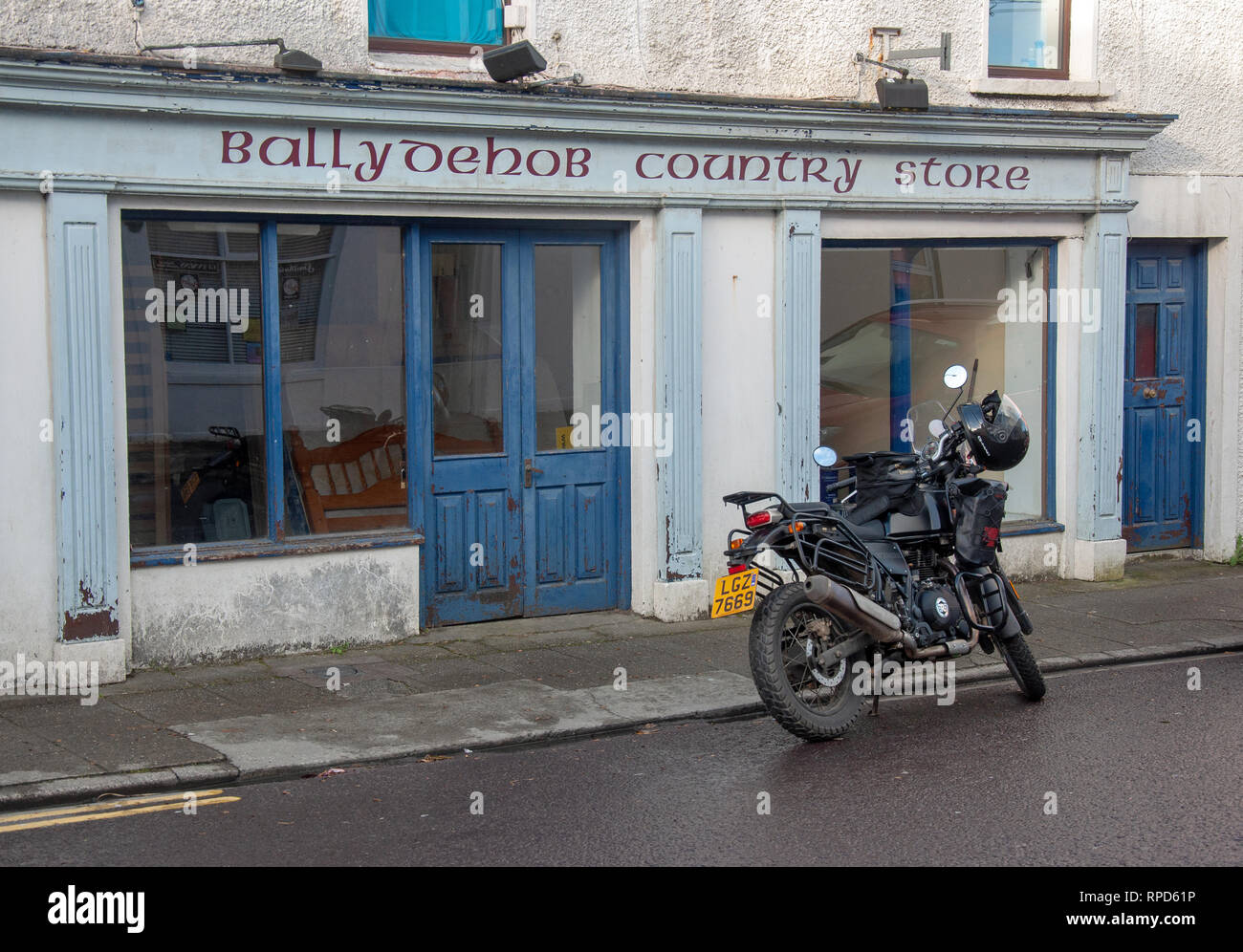 A motorbike parked outside Ballydehob Country Store. Shops in the village have mostly been replaced by tourist restaurants. Stock Photo