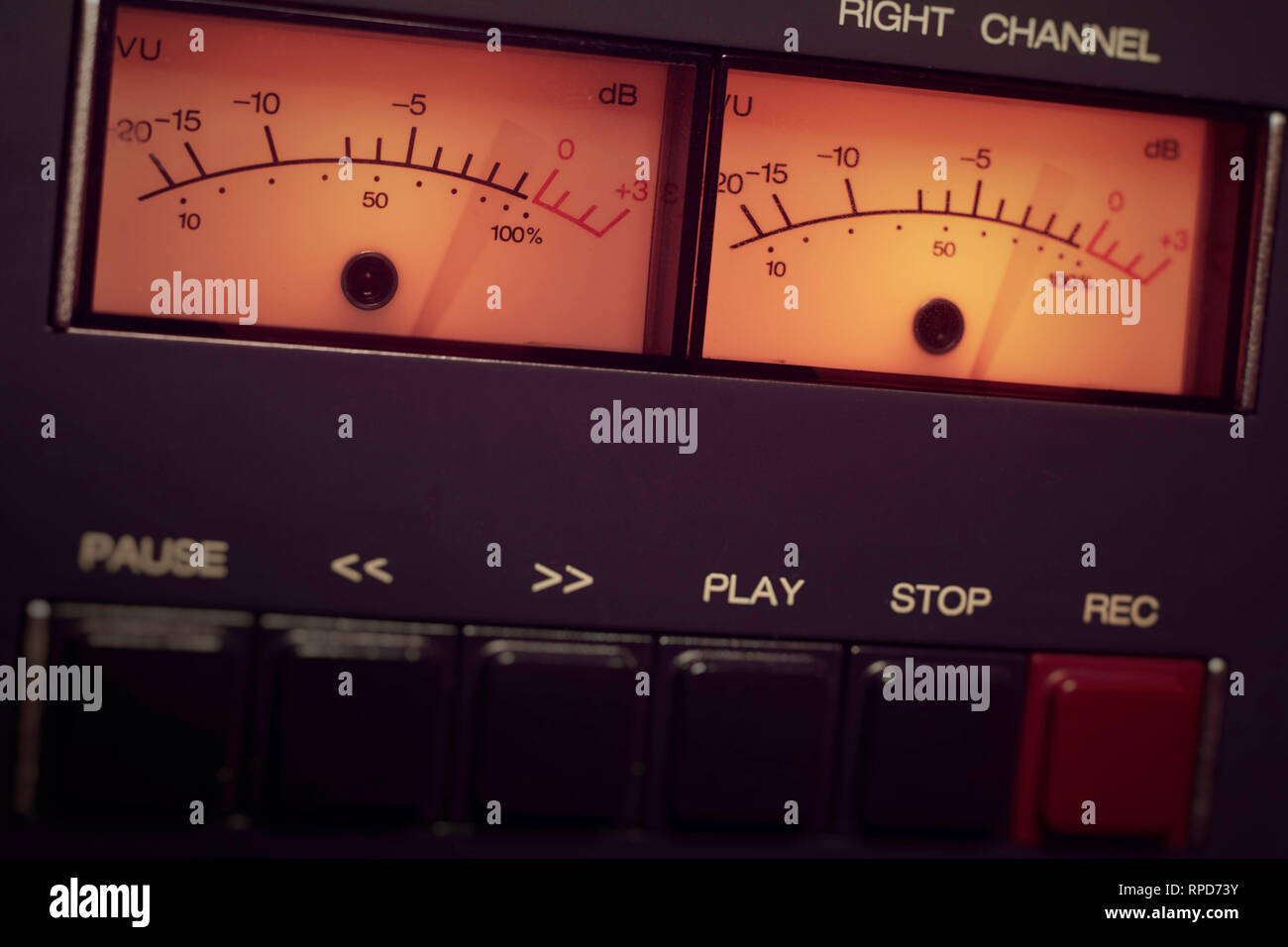Blurred VU meter needles with tape controls on a Revox B77 reel to reel