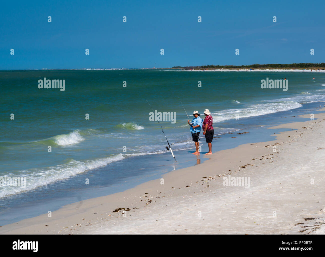 Fort De Soto Park, Florida -- February 17, 2019. Two men are fishing in the waters of the Gulf of Mexico. Stock Photo