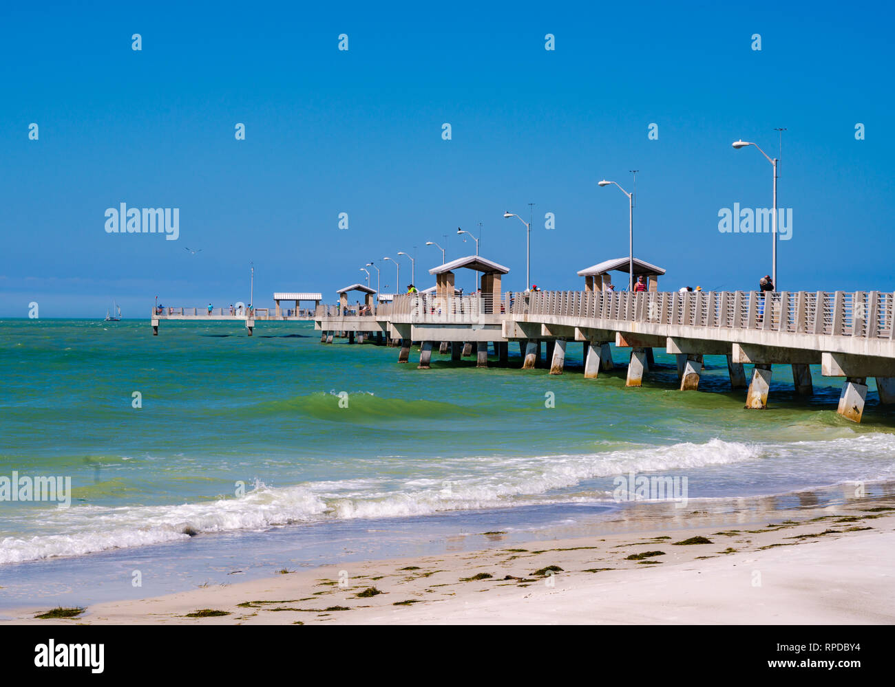 Fort De Soto Park, Florida -- February 17, 2019. Photo of a long pier in the Gulf of Mexico with fishermen and tourists. Stock Photo