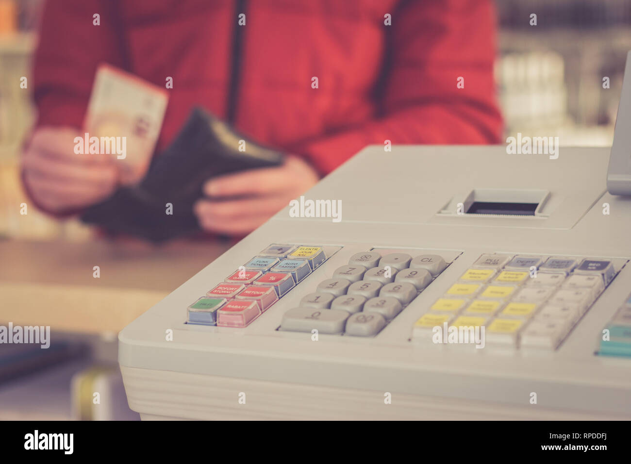 Cash register in a shop: Customer is paying purchase Stock Photo - Alamy