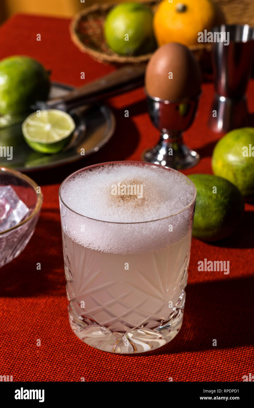 Pisco Sour, a cocktail with Pisco, lime or lemon juice, egg white, and angostura bitter in pop contemporary style. Stock Photo