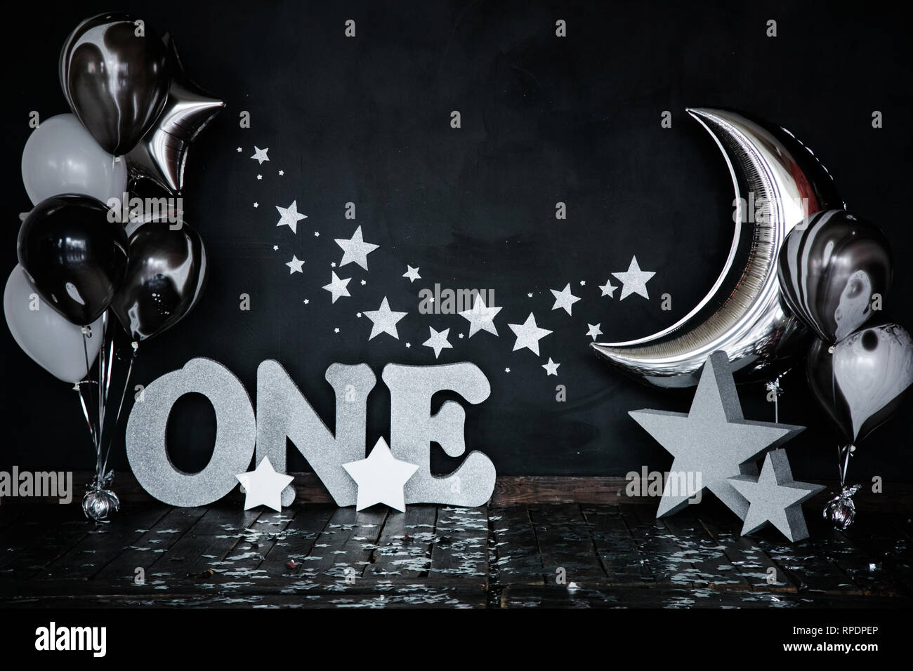 Smashed first birthday white cake with stars and one candle for little baby  boy and decorations. Black background. Big silver letters ONE, silver star  Stock Photo - Alamy