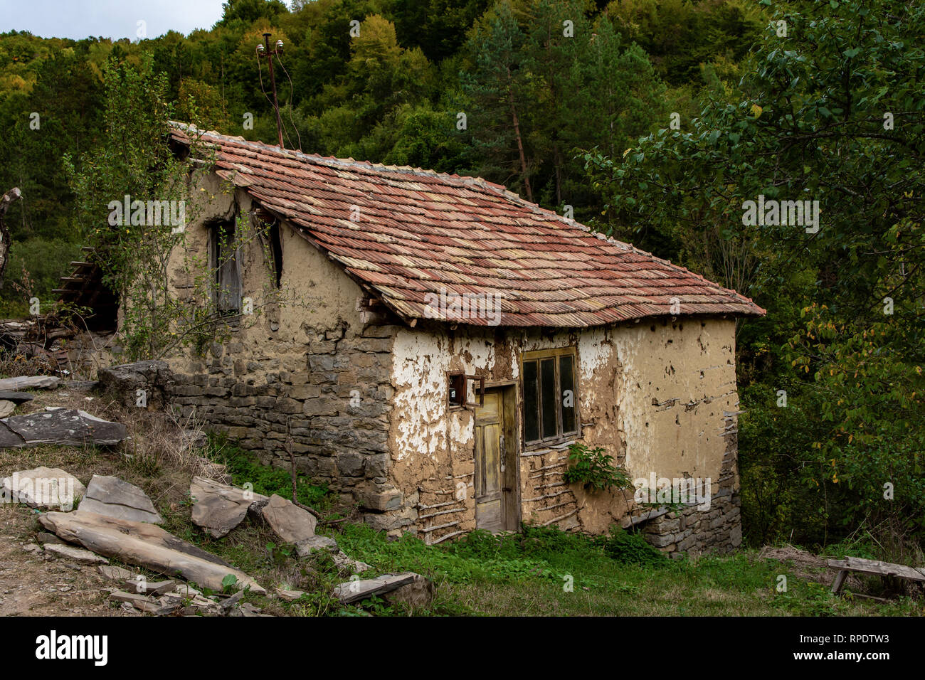 Old village Gostusa, almost abandoned with empty houses, and roofs made of flat rocks. some are completely covered with plants Stock Photo