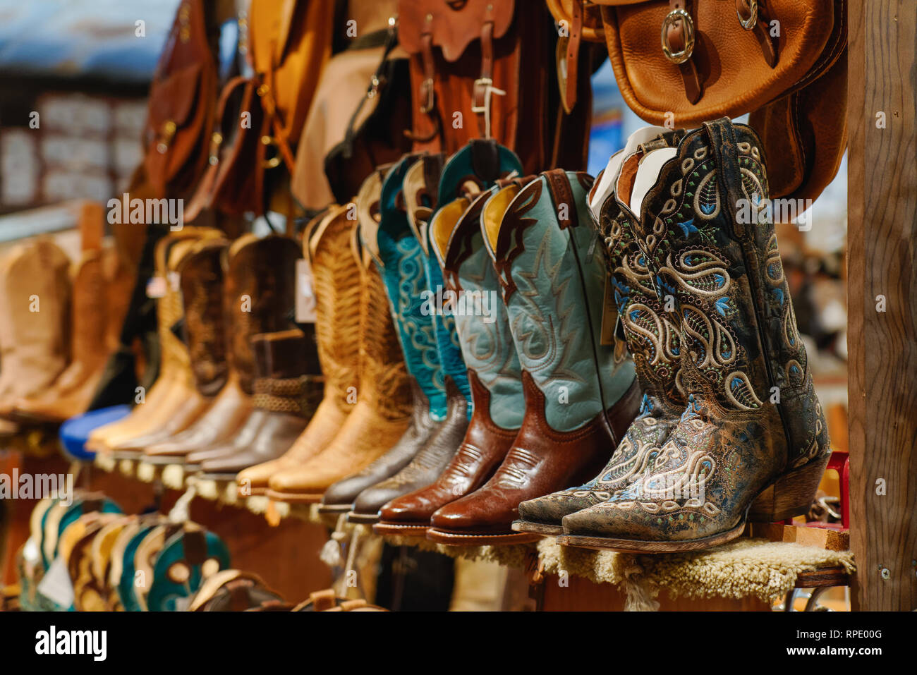 Stylish western boots on a shelf in a store Stock Photo - Alamy