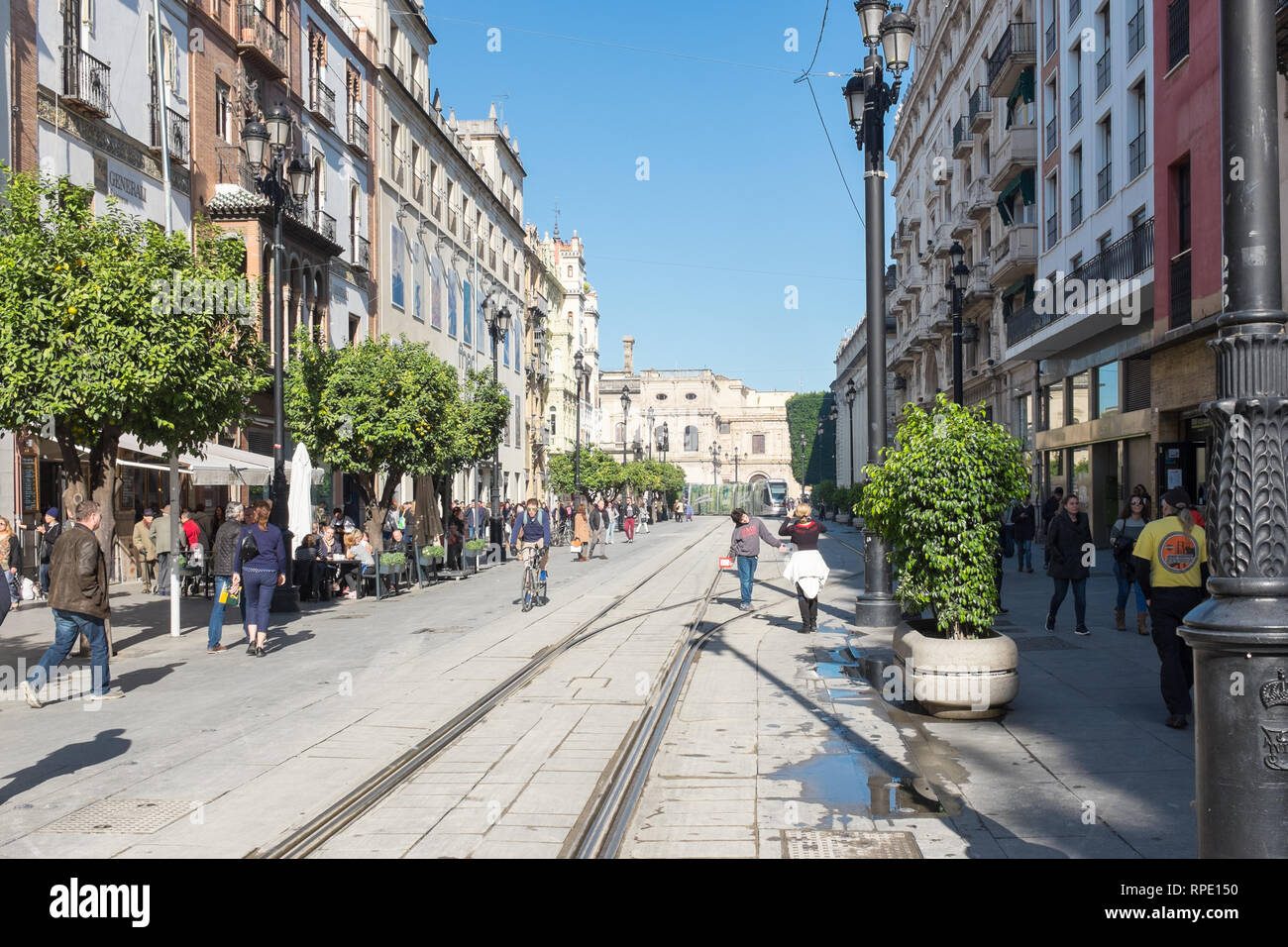Pedestrian street with tramlines leading towards Seville Cathedral Stock Photo