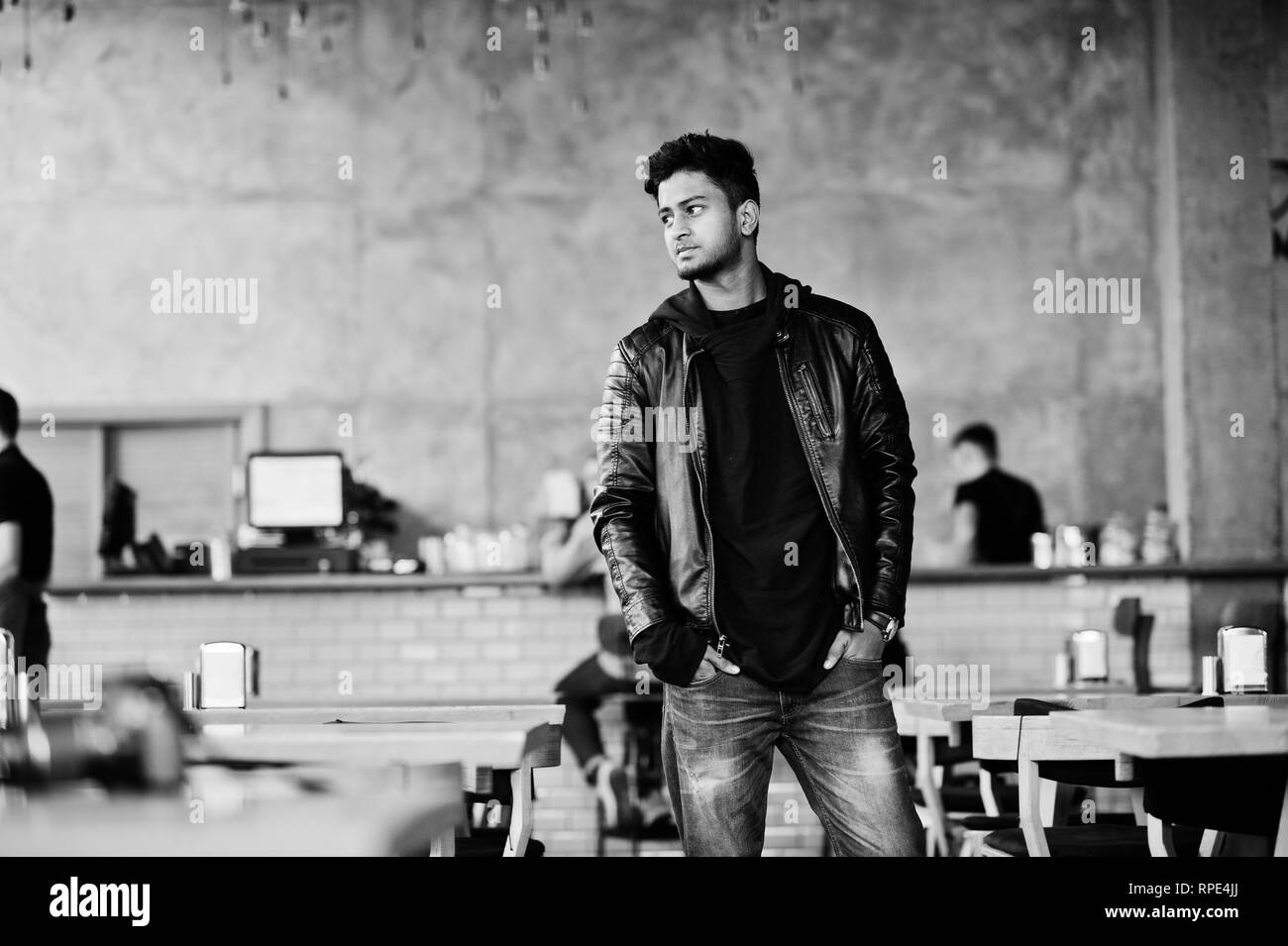 Portrait of stylish and casual young asian man wear on leather jacket spending time at cafe. Stock Photo