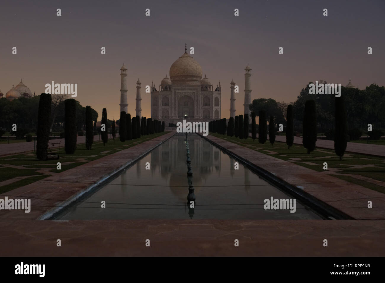 Taj Mahal. The Mughal mausoleum's white marble glistening. Lit by full moonlight alone. An astrological and architectural wonder. Stock Photo