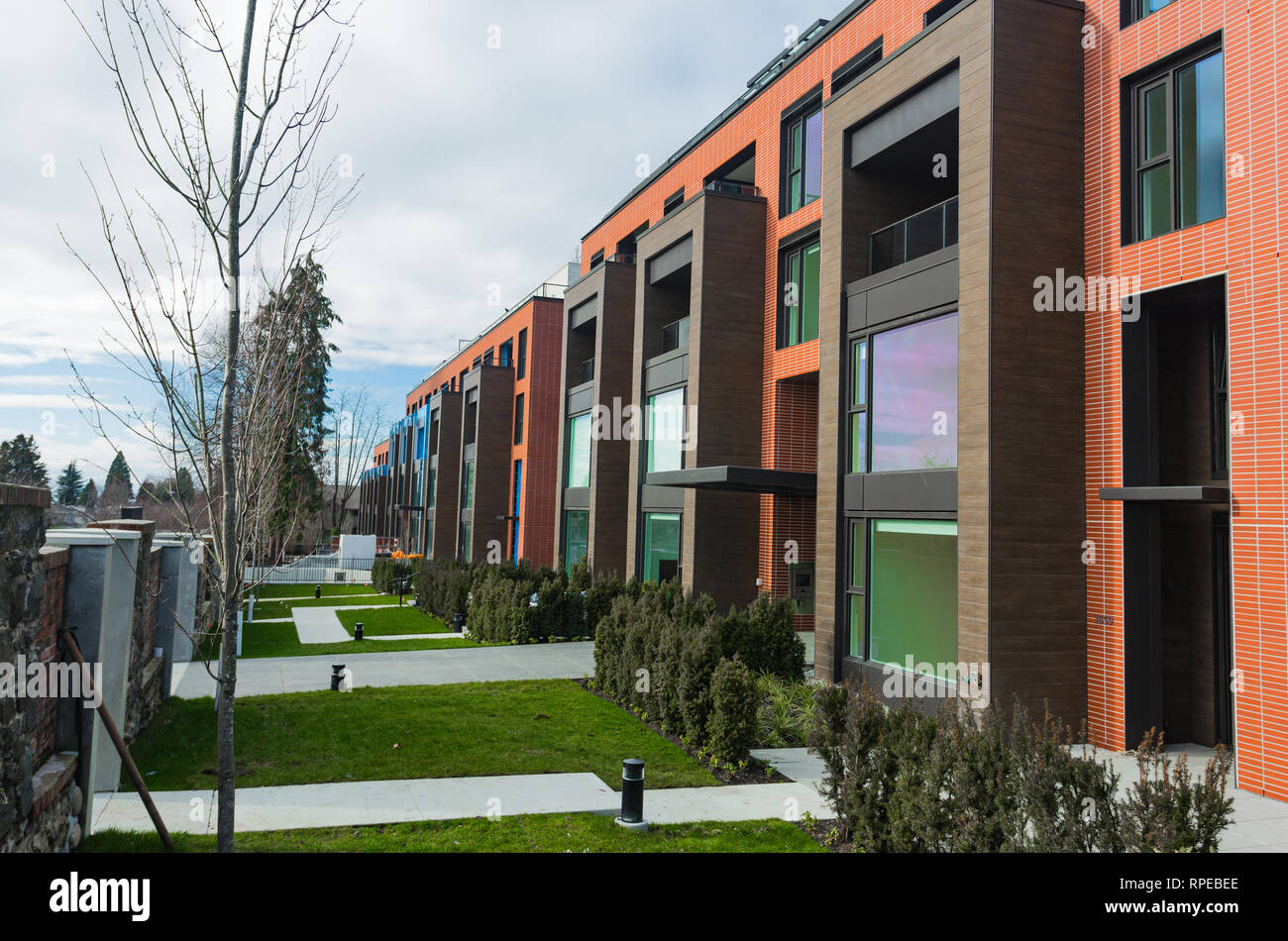 Modern Red Brick Apartment Complex with solid rock fence wall. Home