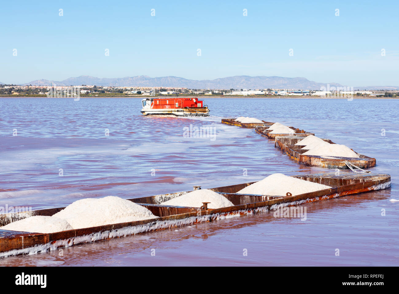 bargues of iron loaded with heaps of coarse salt just extracted from the lagoon Stock Photo