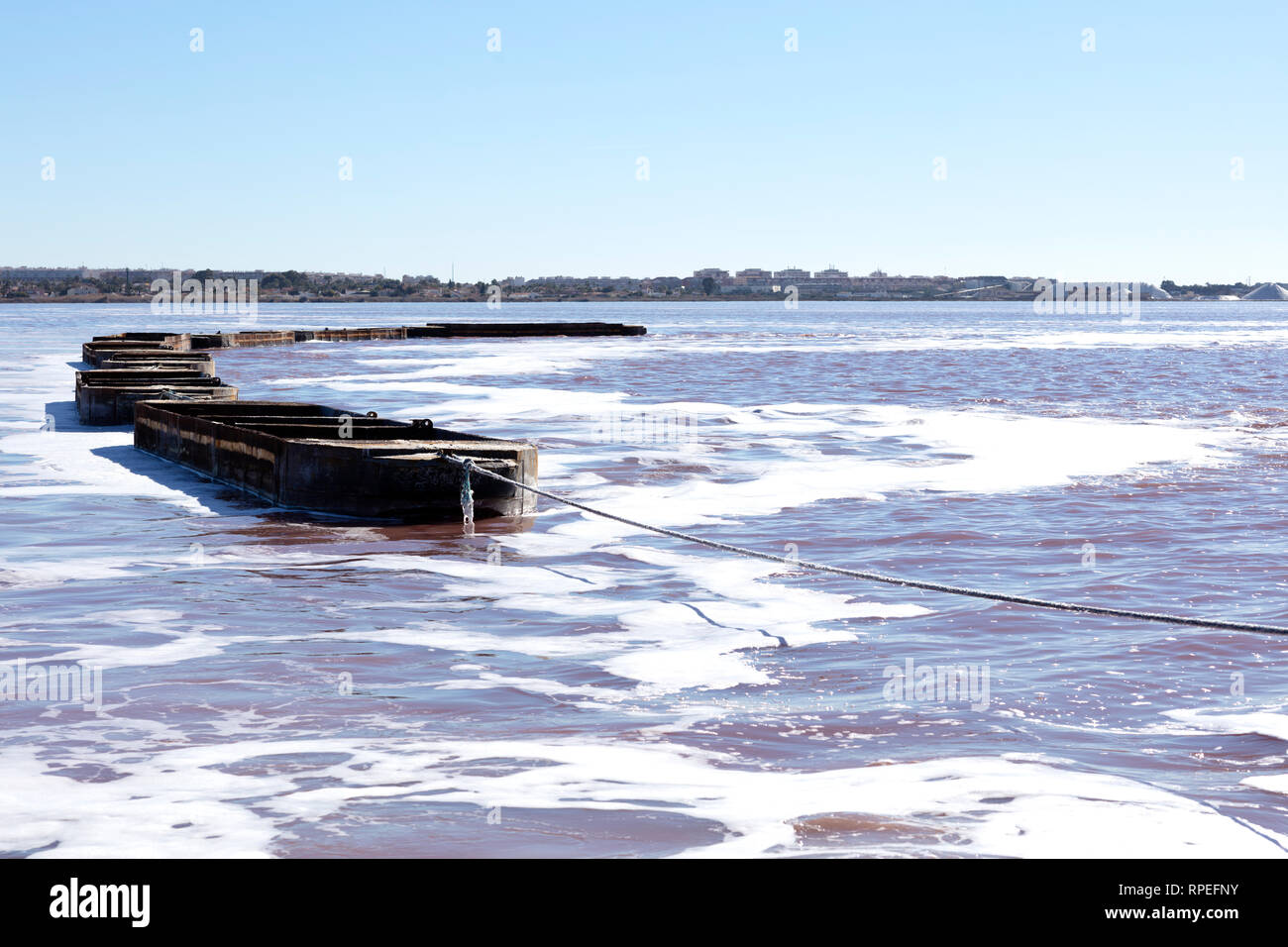 bargues of iron empty floating on salt lagoon Stock Photo