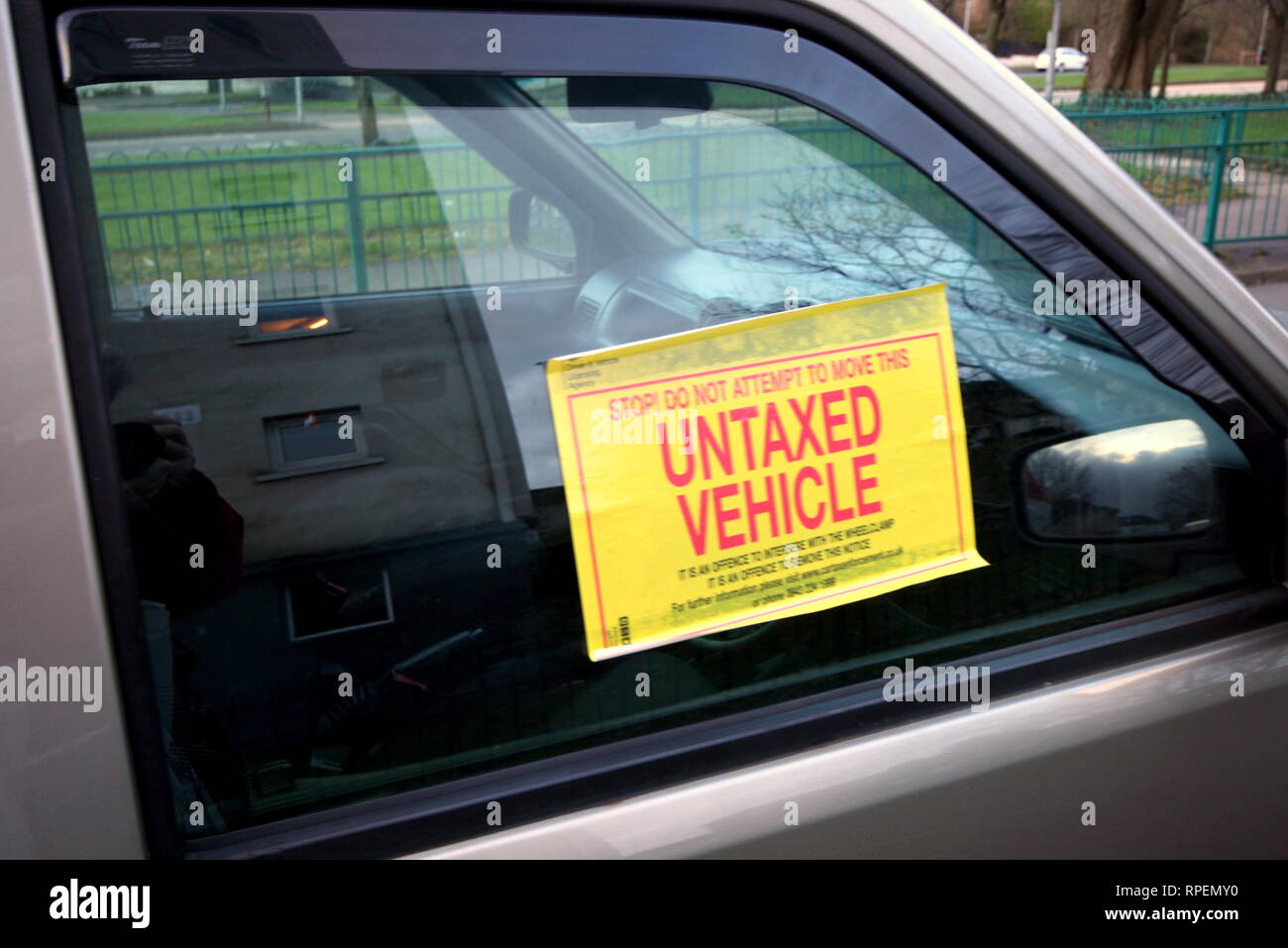 untaxed vehicle as a result of a government crackdown that was combined with a hoarding and TV advertising campaign to pay road tax  cars were clamped Stock Photo