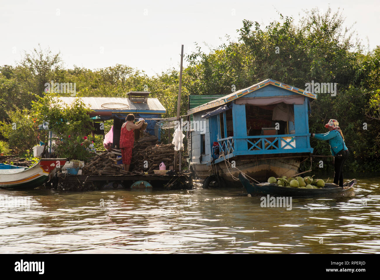 Hanging laundry and produce vendor in the Chong Khneas floating village on Tonle Sap Lake in Cambodia. Stock Photo