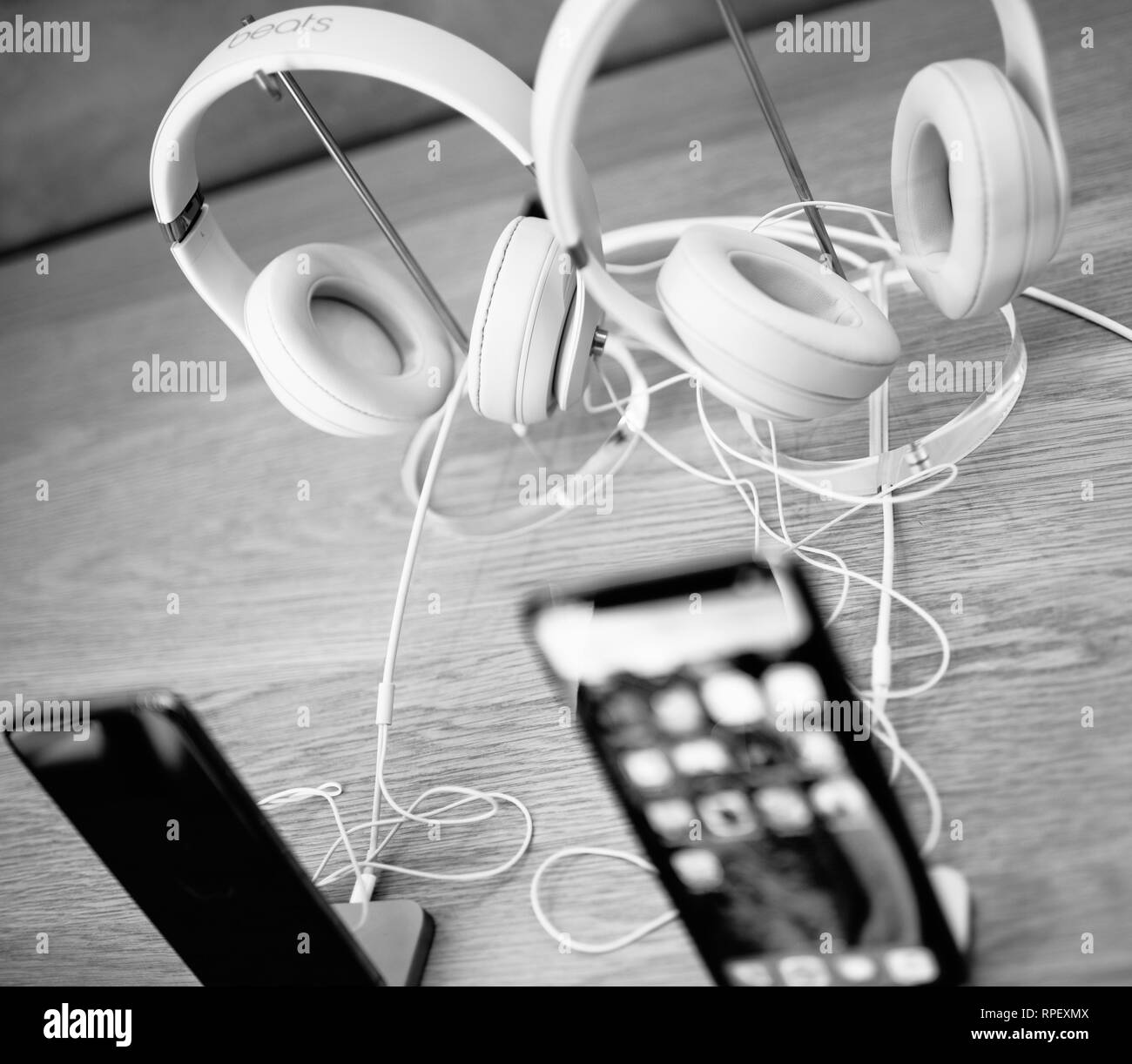 PARIS, FRANCE - OCT 26, 2018: Detail of Apple iphone and Beats by Dr Dre headphones in Apple Store computers Stock Photo