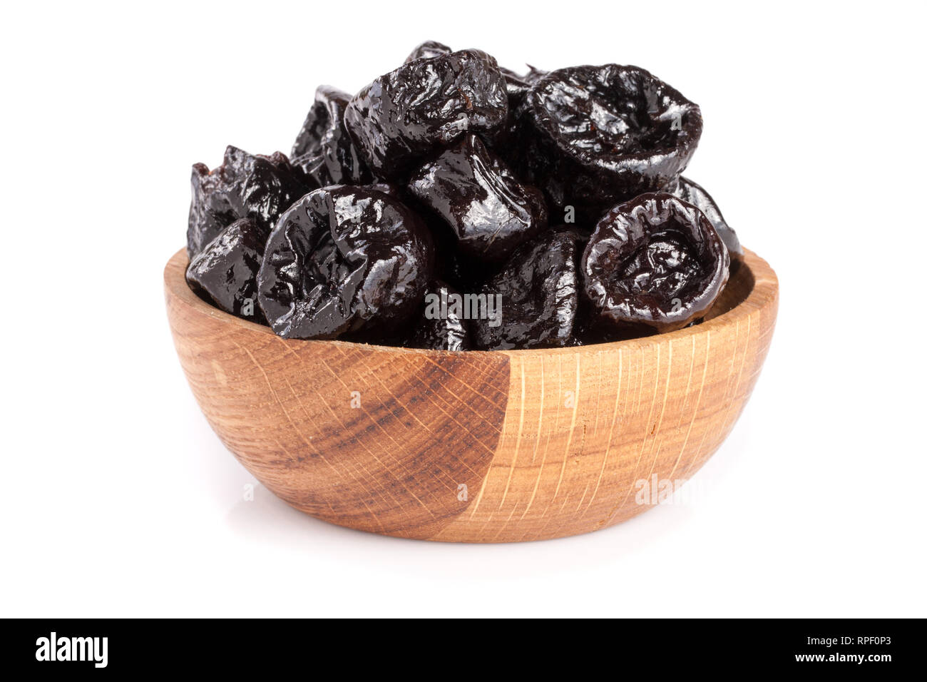 Dried plums or prunes in wooden bowl isolated on white background Stock  Photo - Alamy