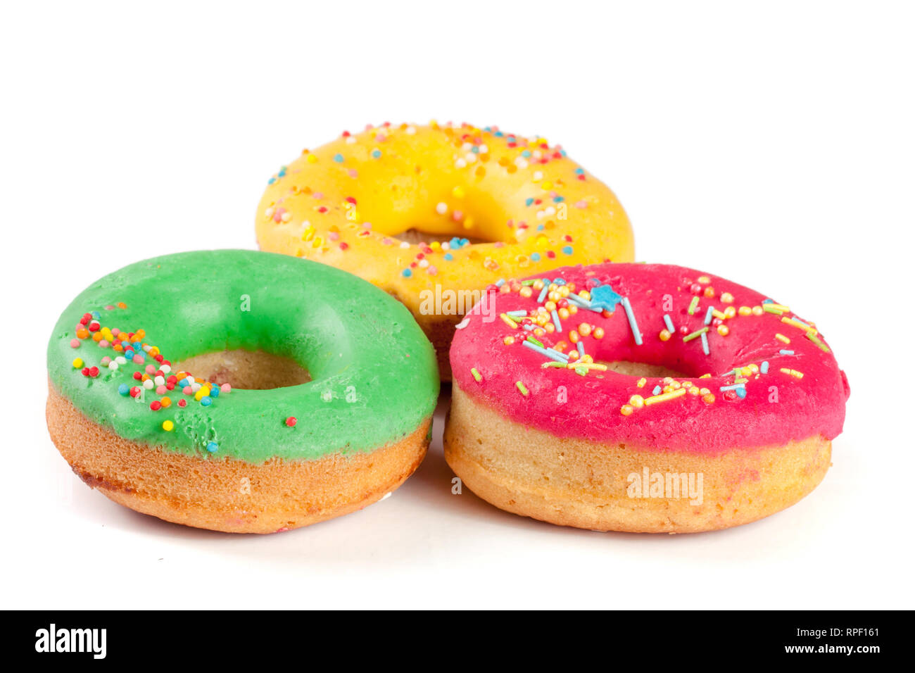 three glazed donut isolated on white background Stock Photo - Alamy