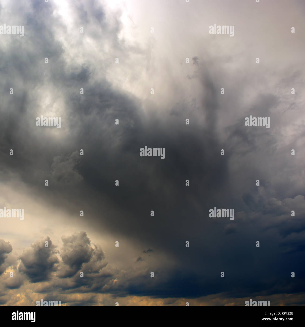 Heavy storm clouds cover the sun. Dramatic sky. Stock Photo