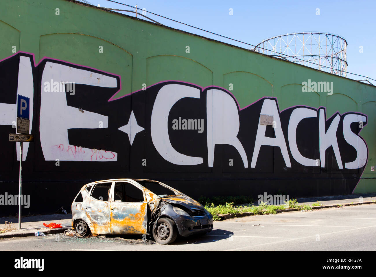 ROME - Graffiti and a burnt out car in the Ostiense / Garbatella quarter. Stock Photo