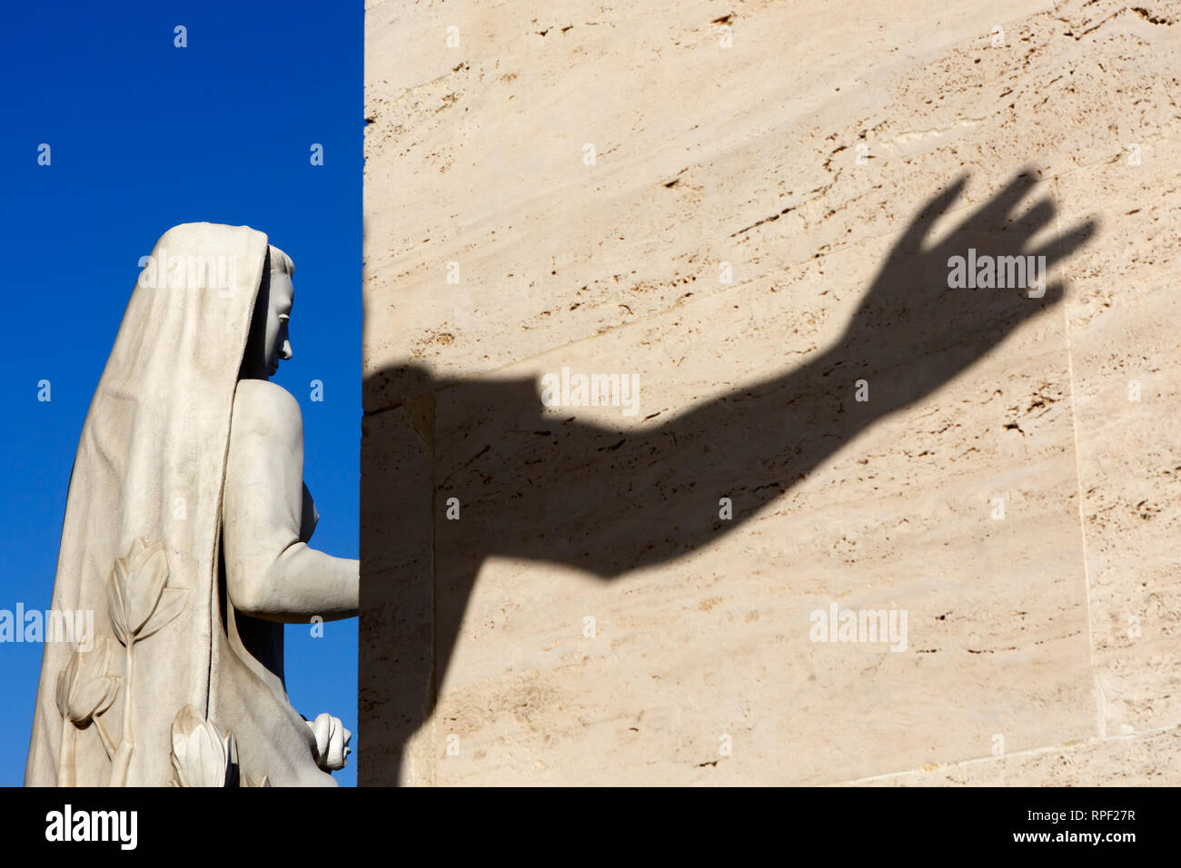 ROME - Detail of a neo classical sculpture and the shadow of an arm at the Palazzo della civilta Italiana, also known as the square colloseum Stock Photo