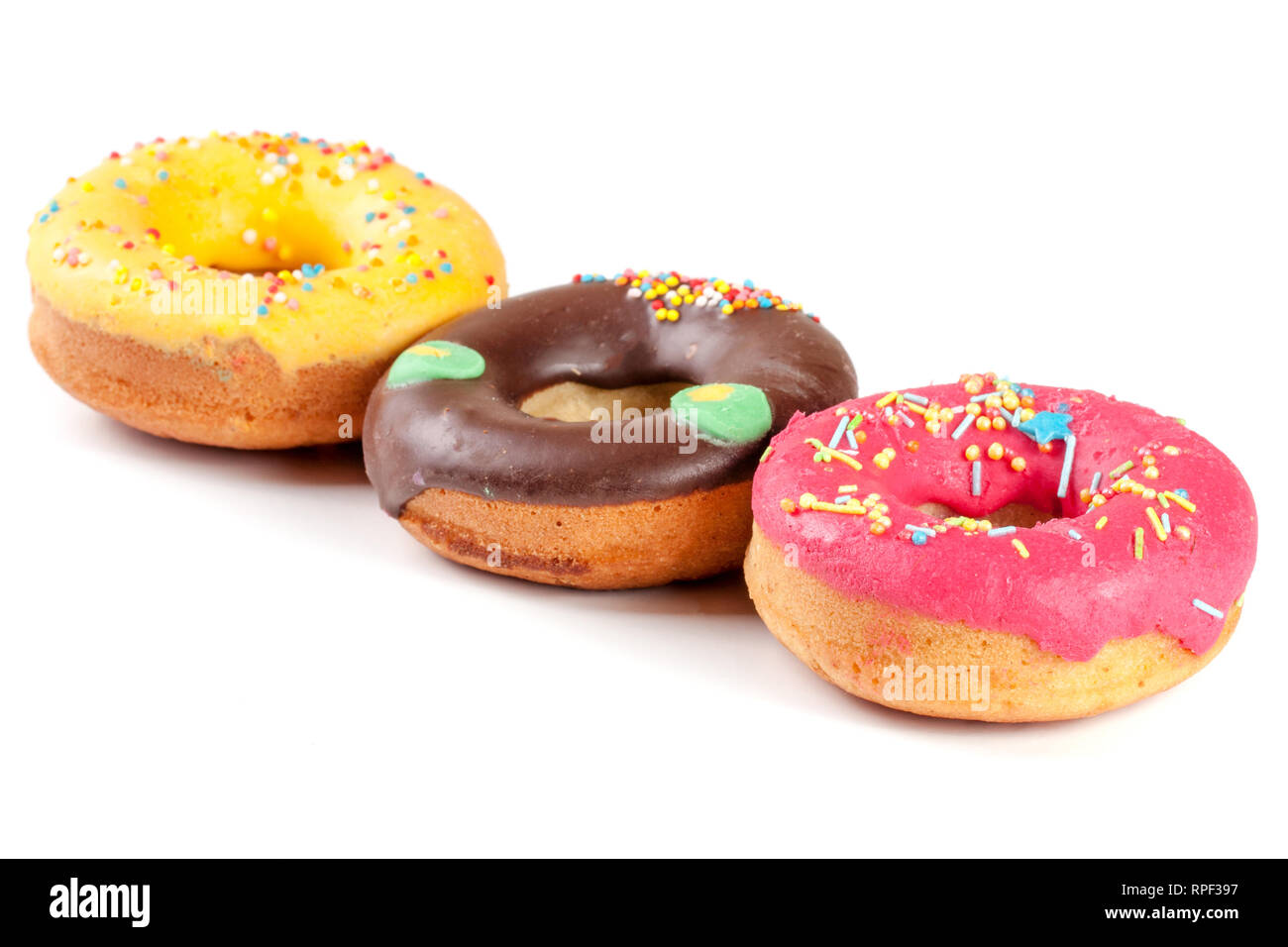 three glazed donut isolated on white background Stock Photo - Alamy