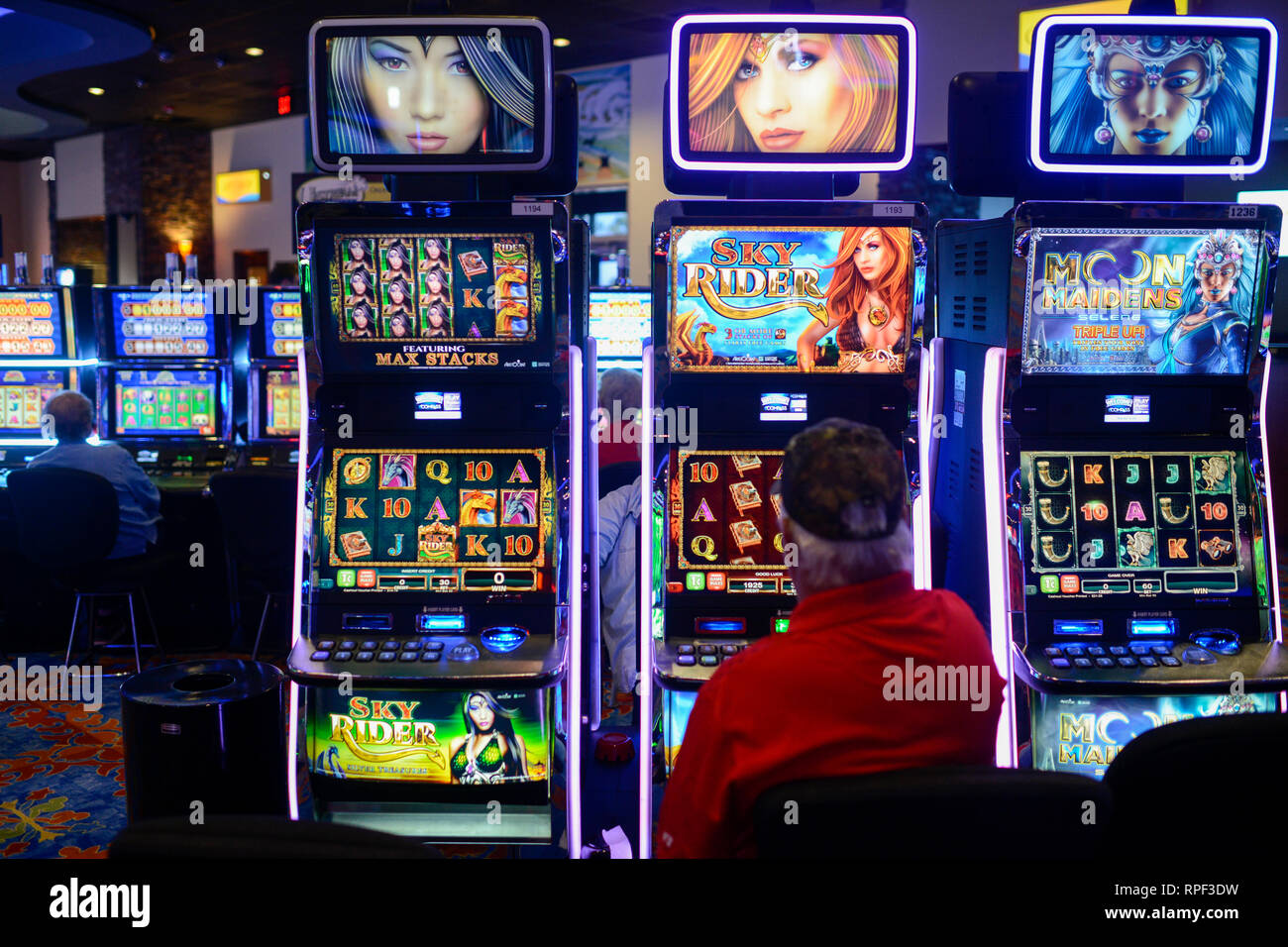 USA, Iowa, Omaha Reservation, Blackbird Bend Casino in Onawa, operated by Native Americans of Omaha Nations, peoples gambling at slot machine, slots Stock Photo