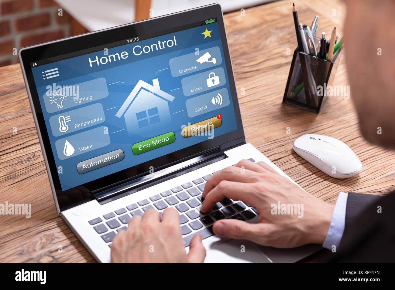 Person's Using Laptop With Home Control Application Stock Photo