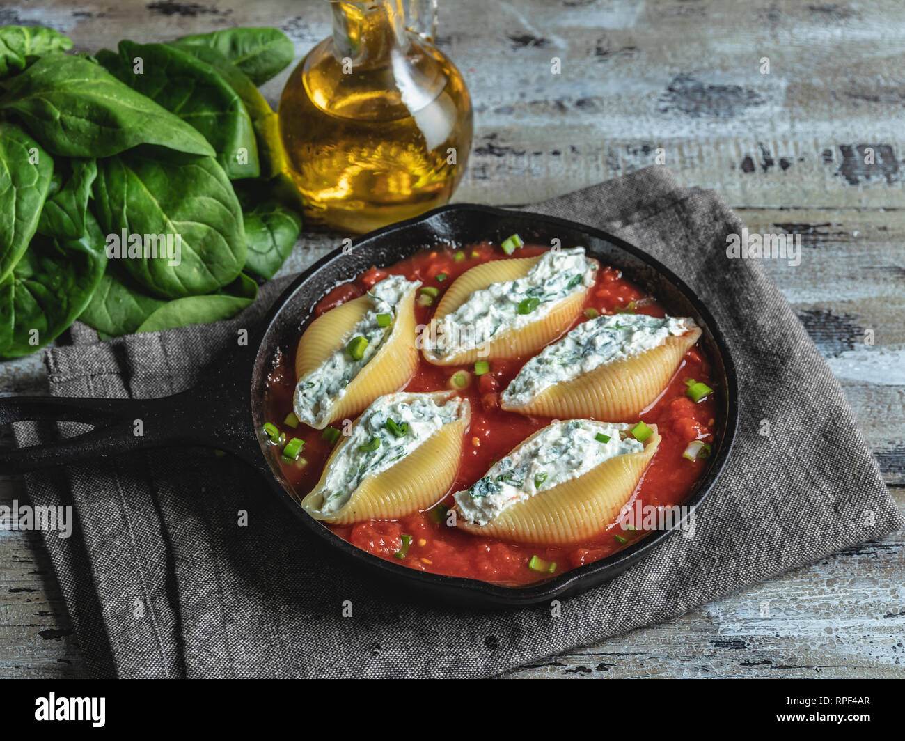 pasta conchiglioni stuffed spinach and cheese, tomato sauce cooked Stock Photo