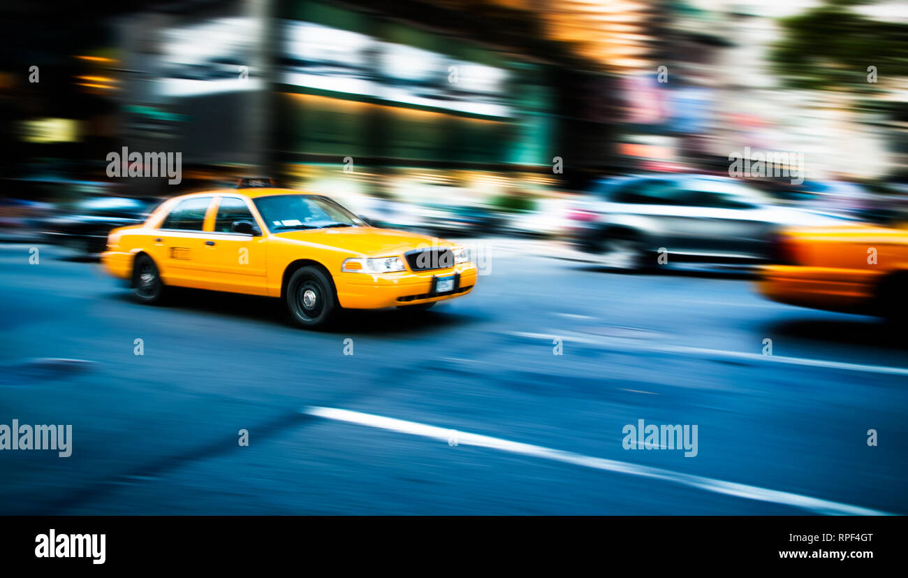 NEW YORK, USA - JUL 16,2010: Yellow cab taxi traditional of New York City in fast movement with motion blur panning, in the busy streets of Manhattan, Stock Photo