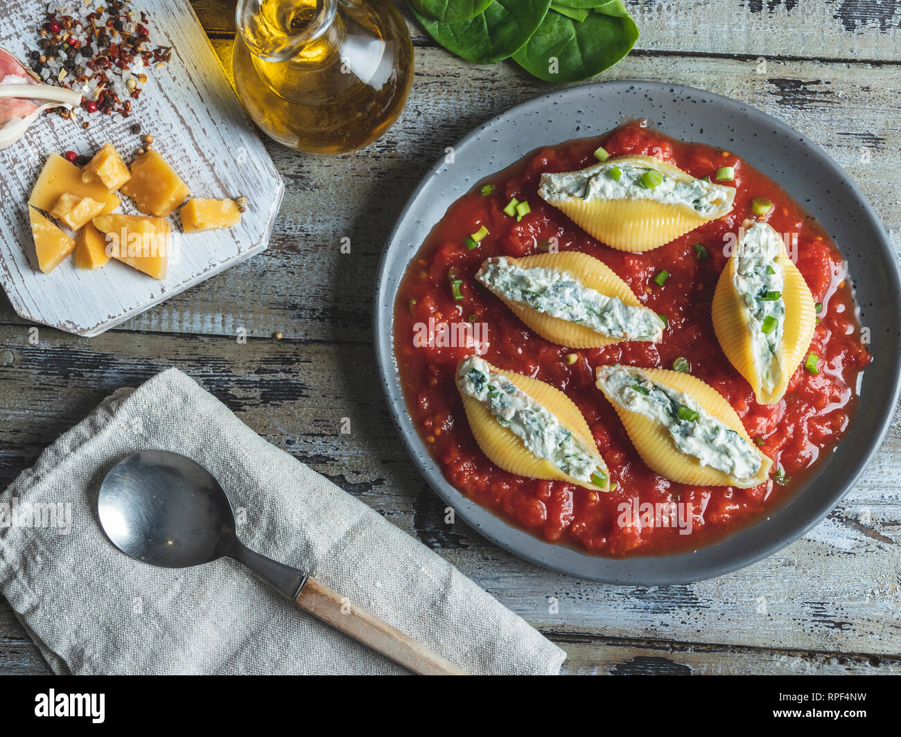 pasta conchiglioni stuffed spinach and cheese, tomato sauce on plate ,cooked Stock Photo