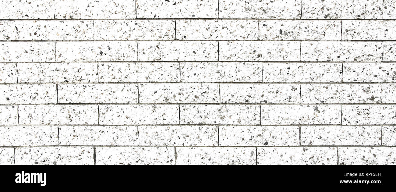 Simple white and grey rectangular stone brick wall as seamless pattern surface texture background in wide panorama banner format. Stock Photo