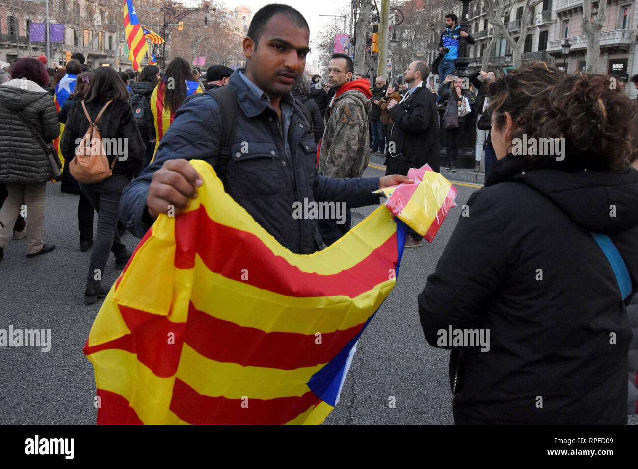 A man of Pakistani nationality sells flags of the independence of Catalonia seen during a general strike in the streets of Barcelona to demand freedom, human right and against the trial of the political prisoners at the Supreme Court. Stock Photo