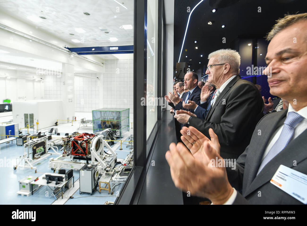 22 February 2019, Baden-Wuerttemberg, Immenstaad: Andreas Hammer (r-l),  Space Coordinator of Airbus Germany, Winfried Kretschmann (Bündnis  90/Grüne), Prime Minister of Baden-Württemberg, and Nicolas Chamussy, Head  of Space Systems at Airbus, watch the