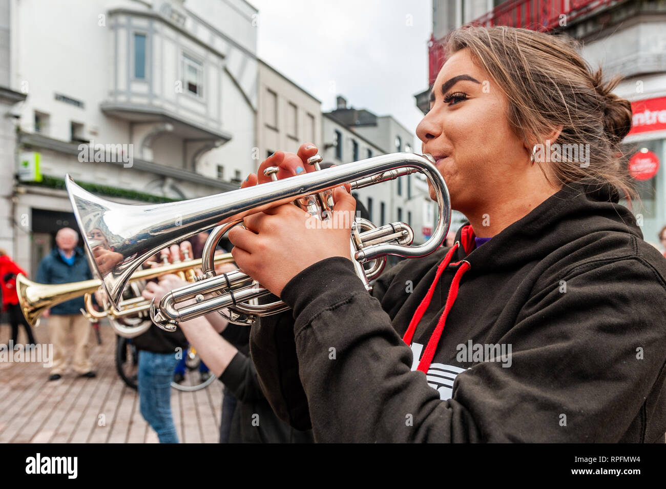 Cork, Ireland. 22nd Feb, 2019. Cork based brass band 'Rebel Brass' played in Cork city centre in front of huge crowds today. The band, made up of 12 to 18 year old young people, played on the Late Late Toy Show in November. Credit: Andy Gibson/Alamy Live News. Stock Photo