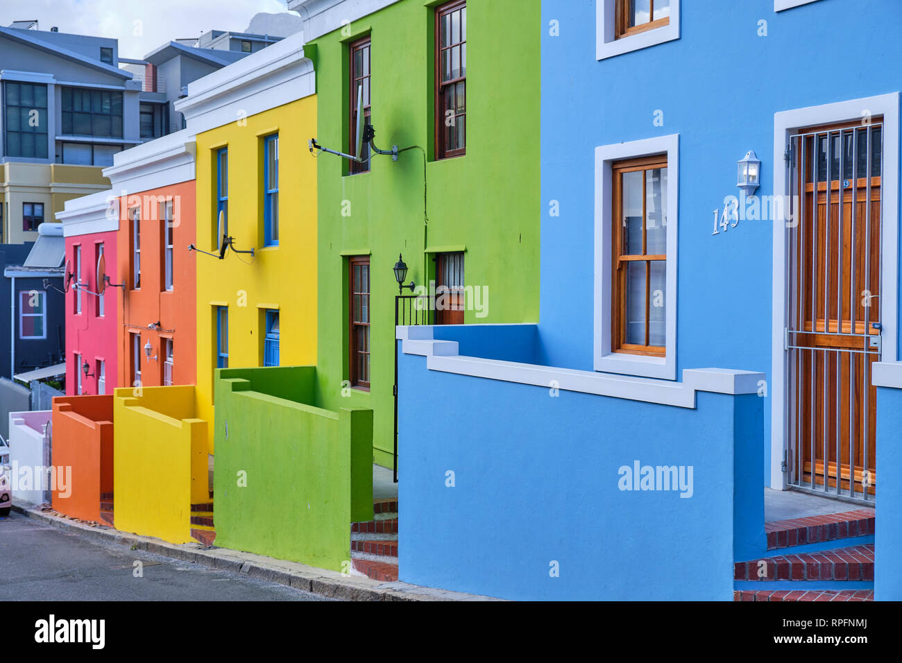 Detail colourful facades of the houses in Bo Kaap, Cape town.  View of uphill side street with newly refreshed colours Stock Photo