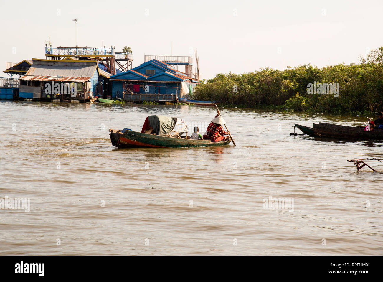 Vietnamese Cambodian family on Tonle Sap Lake, a floating village of non-immigrant foreigners, a community without a country. Stock Photo