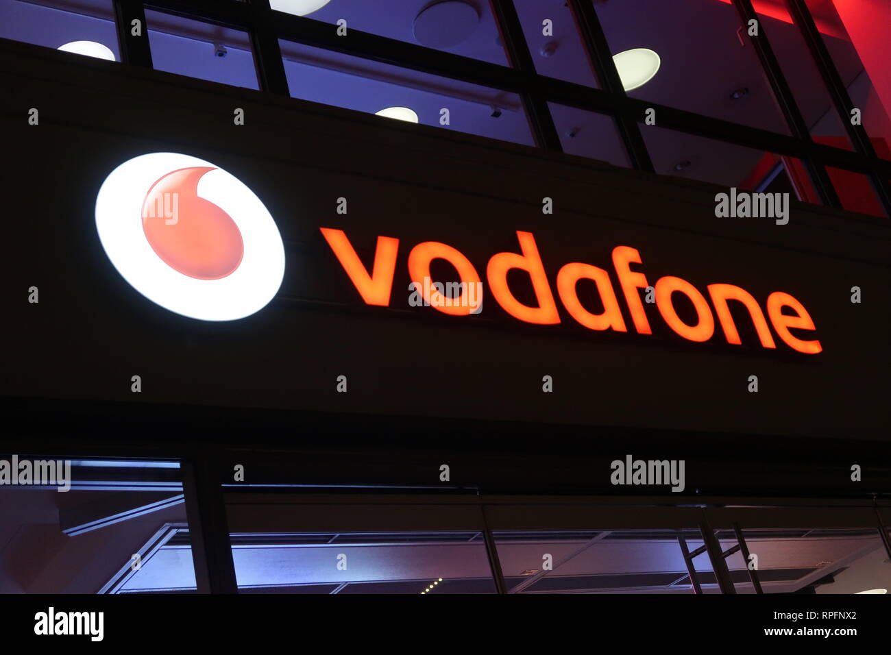 Vodafone shop at night in Munich Stock Photo Alamy