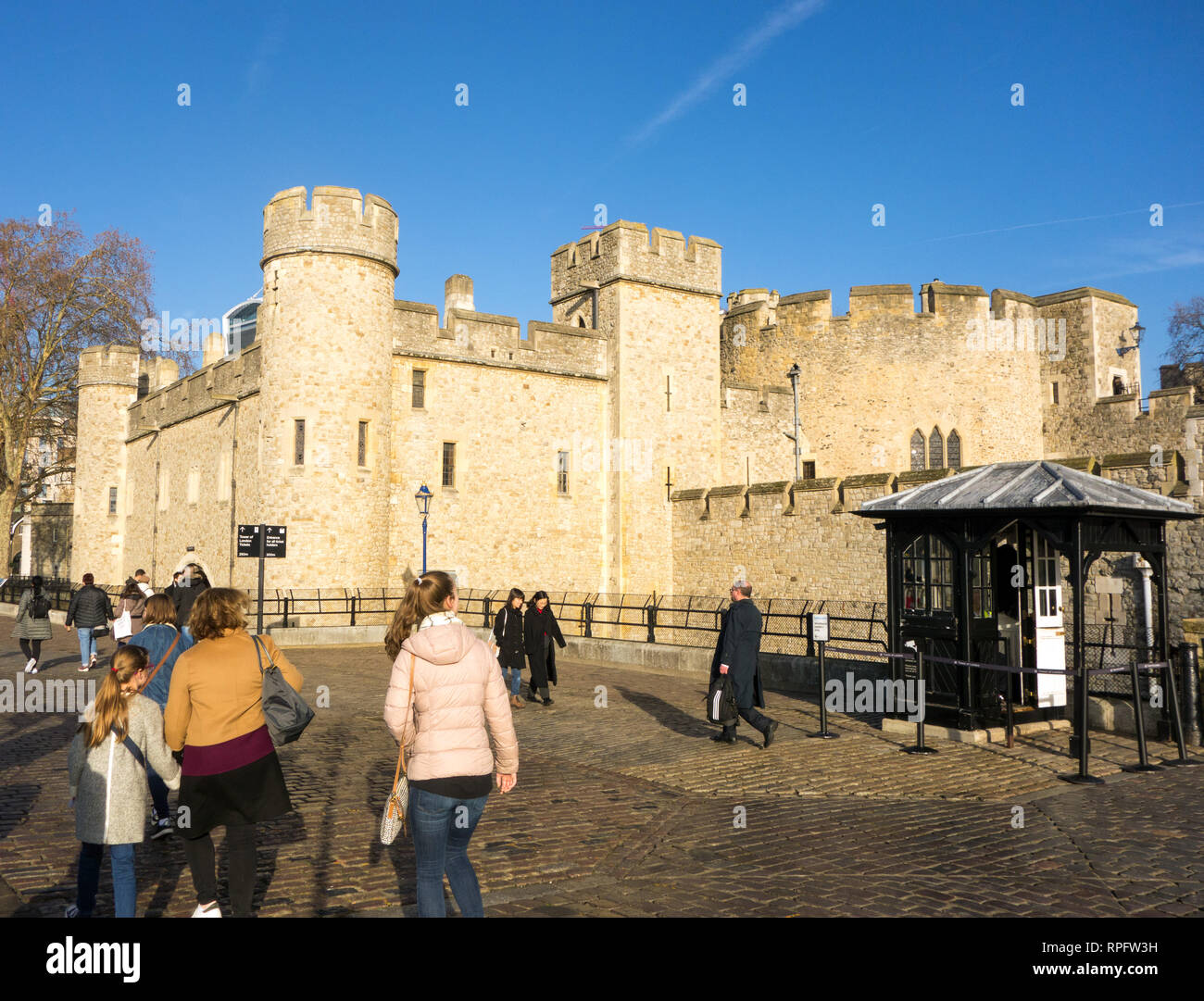The famous London landmark  the Tower of London with blue skies with tourists people sightseers Stock Photo