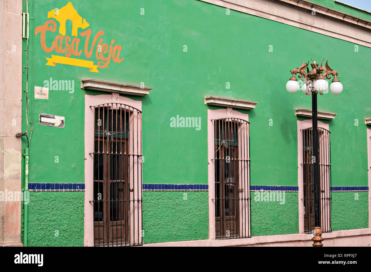 Bright green walls of the Casa Vieja restaurant and bar in the state capital of San Luis Potosi, Mexico. Stock Photo