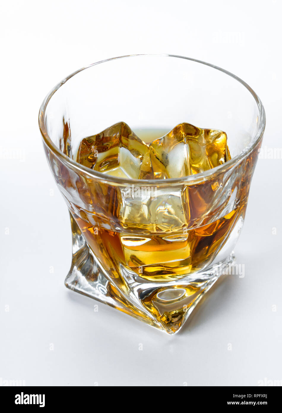 Close up of a tumbler glass with straight Kentucky bourbon served on the  rocks isolated on a white background Stock Photo - Alamy