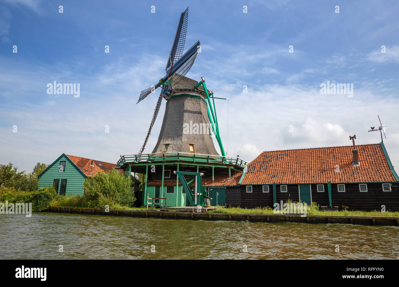 Traditional, authentic dutch windmill at the river Zaam in Zaanse Schans village. Stock Photo