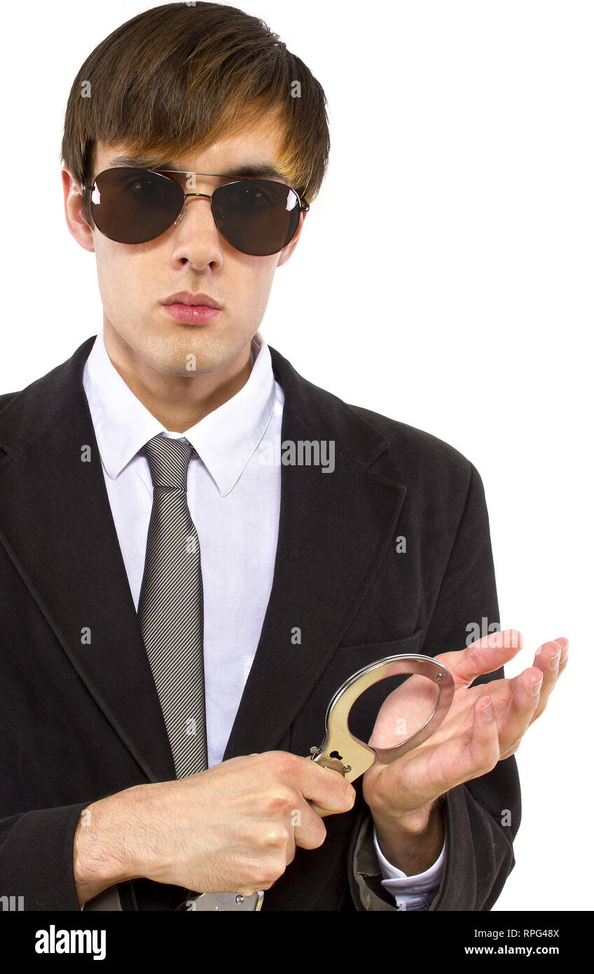 Caucasian male bodyguard wearing sunglasses and black suit Stock Photo