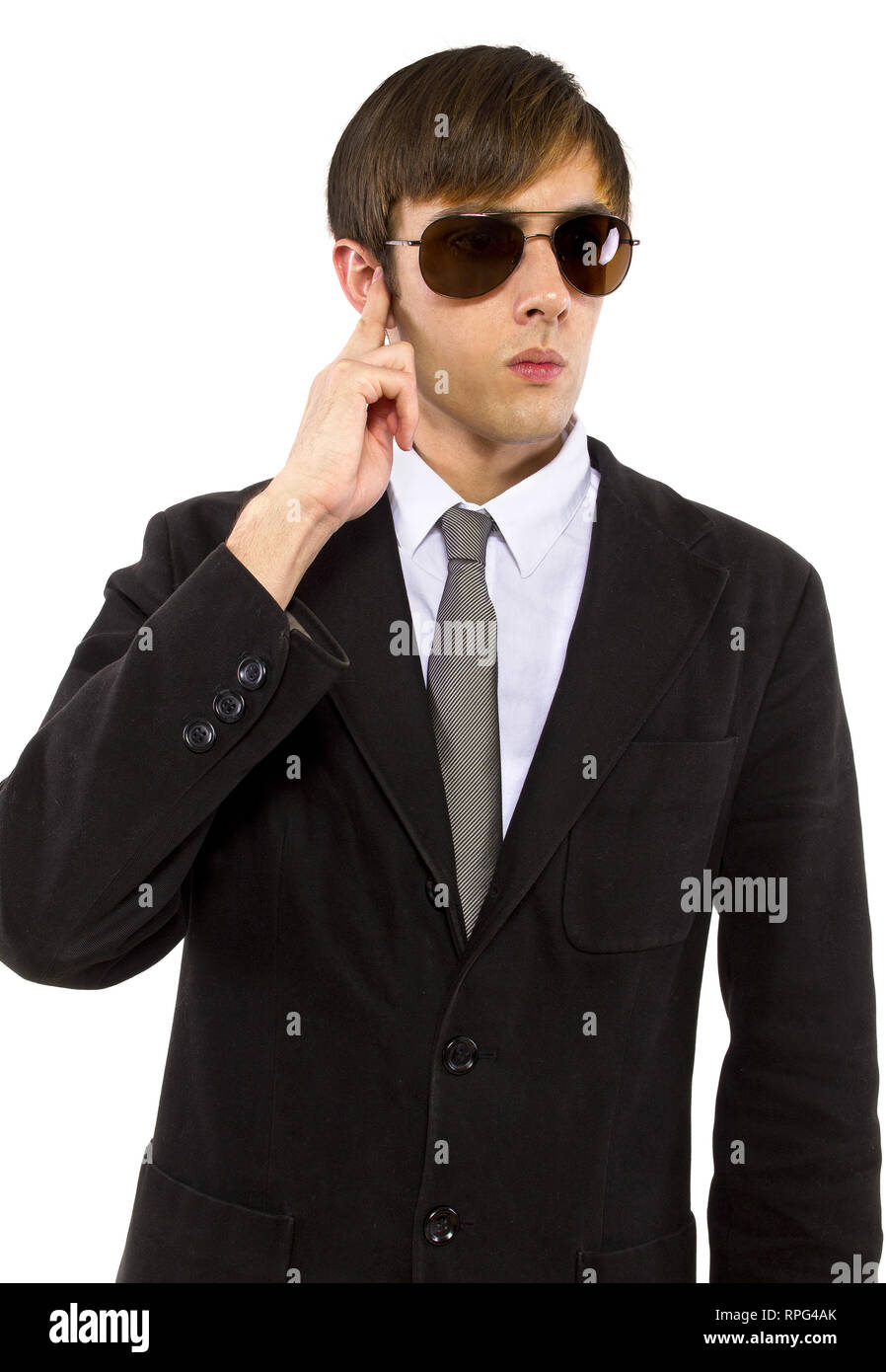 Caucasian male bodyguard wearing sunglasses and black suit Stock Photo