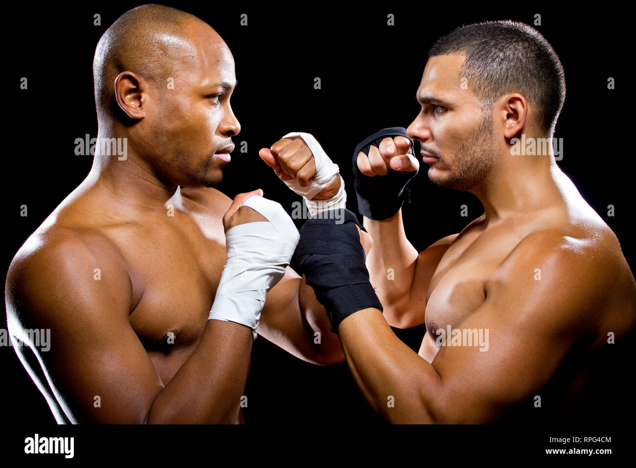 black boxer posing with latino opponent on a black background Stock