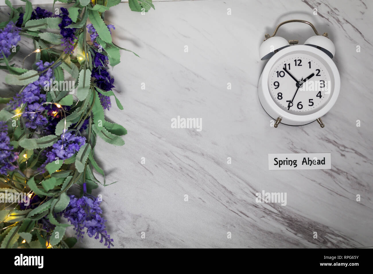 Spring Ahead Daylight Saving Time Concept on gray marble with white ...